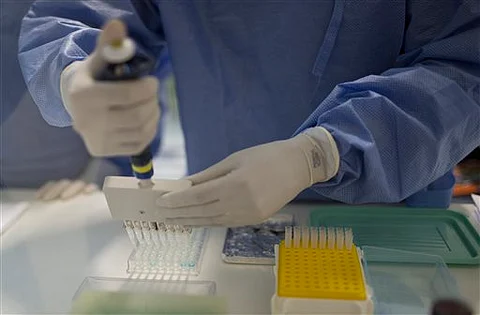 A graduate student works on analyzing samples to identify the Zika virus in a laboratory at the Fiocruz institute in Rio de Janeiro, Brazil. | FIle/AP