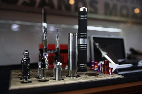 Different vaping pipes, or electronic cigarettes, are viewed for sale at the newly opened Henley Vaporium in New York City. | AFP