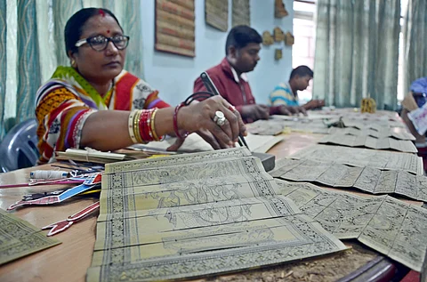 Artists engraving designs on palm leaves at the workshop on Monday | Express