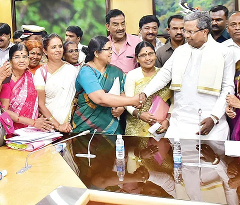 Chief Minister Siddaramaiah with representatives of the Anganwadi workers at Vidhana Soudha, in Bengaluru on Monday | Express Photo Service