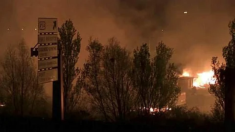 A huge blaze ravaged the migrant camp in northern France on Monday, destroying wooden shelters and forcing the evacuation of hundreds of migrants, hours after a clash involving up to 150 migrants, the prefecture of the region said. (AP Photo)