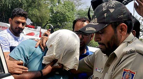 Officials of Delhi Police Crime Branch escort Sukesh Chandrashekar. (Photo | PTI)