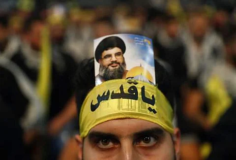 A Hezbollah supporter, wears an Arabic headband that reads:'Hey Quds' with a portrait of Hezbollah leader Sayyed Hassan Nasrallah. (File|AP)