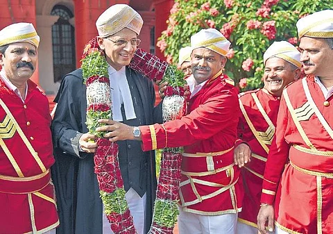 Bengaluru Jamedars garlanding Justice A S Bopanna, who is appointed as Chief Justice of Gauhati High Court on Friday, after the farewell programme held at Karnataka High Court | Nagaraja Gadekal