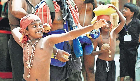 A young devotee breaks coconut at Sannidhanam on Tuesday | Melton Antony