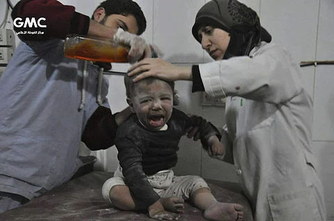 Syrian paramedics treat a kids who was wounded during airstrikes and shelling by Syrian government forces, at a makeshift hospital, in Ghouta, suburb of Damascus, Syria. | AP