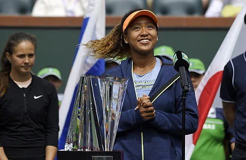 Naomi Osaka, right, of Japan, poses with her trophy after defeating Daria Kasatkina, left, of Russia, in the women's final at the BNP Paribas Open tennis tournament. | AP