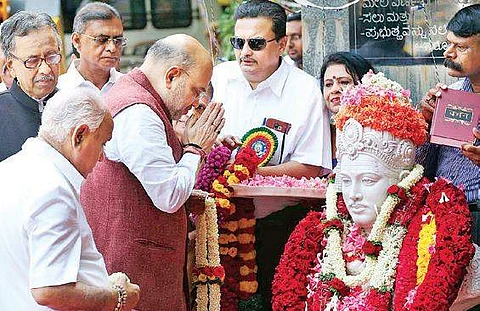 BJP national president Amit Shah and BJP state president  B S Yeddyurappa paying floral tributes to a Basava statue on the occasion of Basava Jayanthi in Bengaluru on Wednesday. | Express