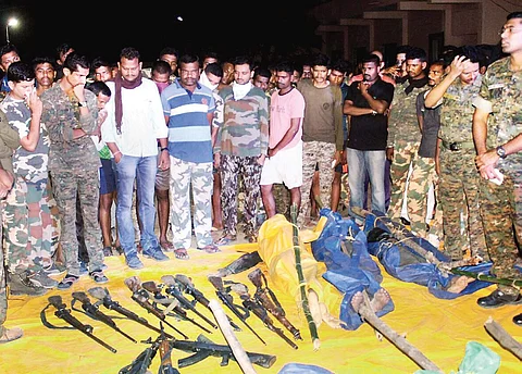 Security personnel display weapons recovered from the Maoists killed in the Gadchiroli encounter in Maharashtra on April 22;