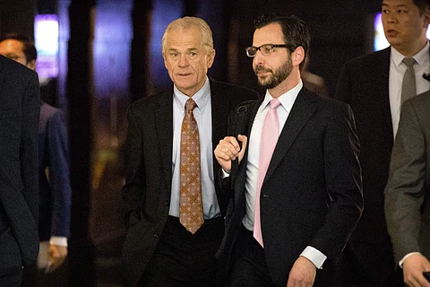 White House trade adviser Peter Navarro, left, leaves his hotel for the meeting in Beijing. (Photo | AP)