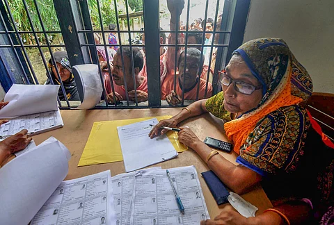 People wait in a queue to check their names on the final draft of the state's National Register of Citizens after it was released at an NRC Seva Kendra in Assam. (PTI)