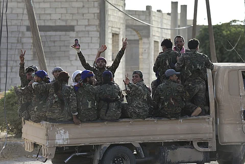 Arab and Kurdish fighters with the US-backed Syrian Democratic Forces, gather on a pickup as they move to the front line to battle against the IS militants. (File Photo | AP)