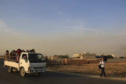Syrians flee shelling by Turkish forces . (Photo | AP)