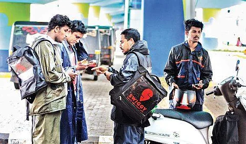 A file photo of food delivery personnel waiting for app notification.  A Sanesh