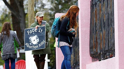 In this March 20, 2018, file photo, anti-abortion sidewalk counselors call out to a woman entering the Jackson Women's Health Organization's clinic, the only facility in the state that performs abortions, in Jackson. (Photo | AP)