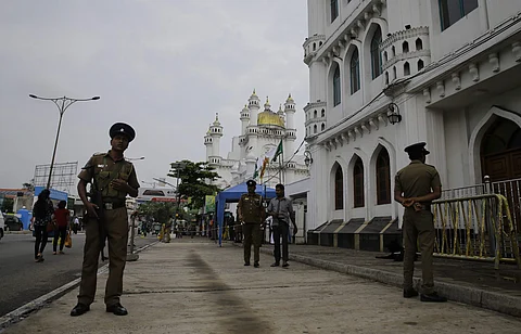 Sri Lankan police officers stand guard outside a Sufi Islamic mosque during Friday prayers in Colombo. (Photo | AP)