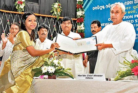 CM Naveen Patnaik handing over appointment letters to a civil service officer