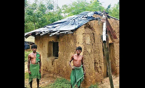 TMC's cut money row victim Bharat Mallick, a daily wage labourer, and his brother in front of their dilapidated house at Dahijuri village. (Photo | Pranab Mandal, EPS)