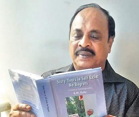 Mohammed Kutty reading the autobiography of B M Kutty at his residence in Tirur