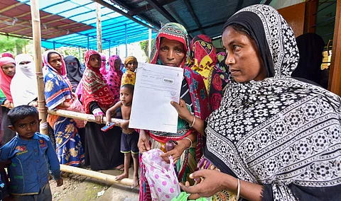 People check their names on the final draft of the state's National Register of Citizens after it was released, at a NRC Seva Kendra in Nagaon, Assam. (Photo | PTI)