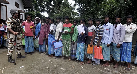 People stand in a queue to check their names on the final list of the National Register of Citizens. (Photo|PTI)