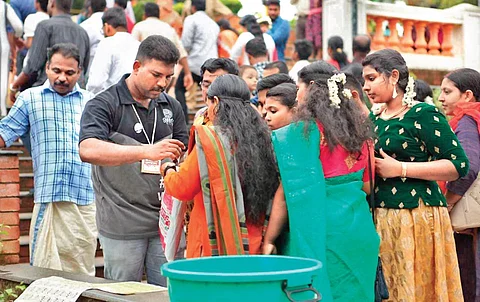 Volunteers of the Green Army attach stickers on single-use water bottles and food wrappers