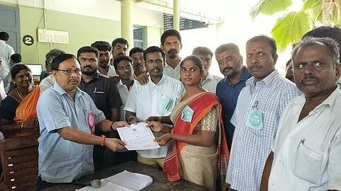 Riya receiving the certificate of victory from the returning officer in Tiruchengode in Nammakal district. (Photo | Express)