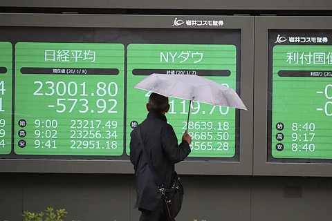 A man looks at an electronic stock board of a securities firm in Tokyo.