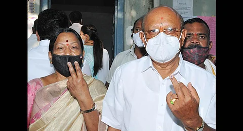 T B Jayachandra, Congress candidate for Sira, and his wife Nirmala after casting their votes, on Tuesday | Express