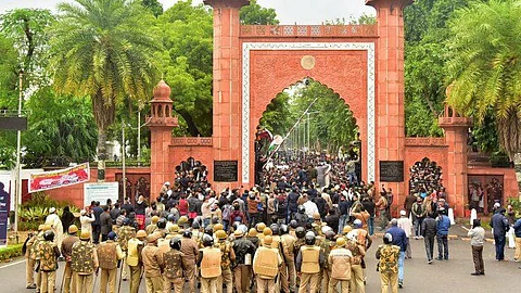 Police personnel stand guard outside Aligarh Muslim University as students protest against the passing of Citizenship Amendment Act. (File Photo | PTI)