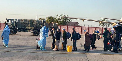 Medics screen passengers, who were airlifted from Iran, before being sent for a mandatory isolation period to an Indian Army Wellness Facility in Jodhpur. (photo| Twitter/ @PRODefRjsthn)