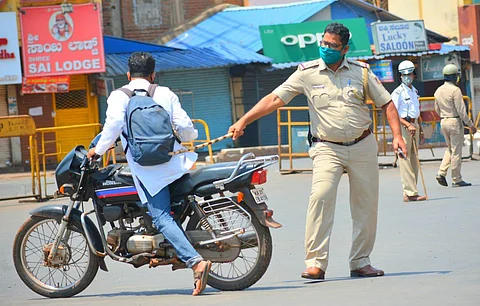 A policeman pulls up a violator of the lockdown in Karnataka. (Photo | D Hemanth, EPS)