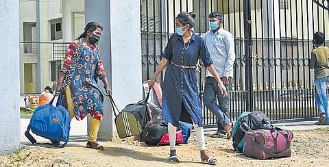 Students from Bangalore University vacate their hostel after authorities decided to turn the premises into a Covid centre | vinod Kumar T