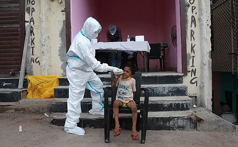A health worker takes a nasal swab sample for COVID- 19 testing through rapid antigen methodology in New Delhi on Friday. (Photo | Shekhar Yadav/EPS)