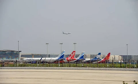 A plane lands at IGI Airport as others stand parked during Unlock 2 in New Delhi. (Photo | PTI)
