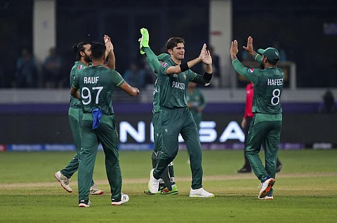 Pakistan's Shaheen Afridi, centre, celebrates with teammates after dismissing Indian cricket captain Virat Kohli. (Photo | AP)