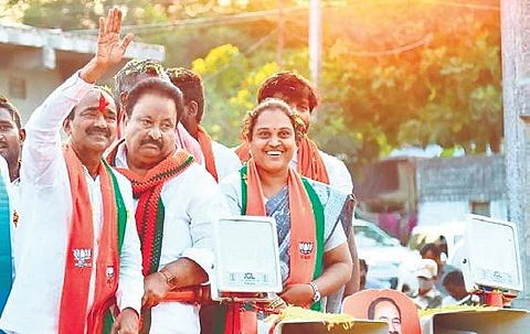 BJP candidate Eatala Rajender waves to the crowd during his poll campaign in Ellandakunta mandal on Tuesday