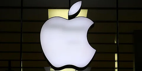 The Apple logo illuminated at a store.