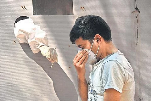 A health worker takes a swab sample (Representational Image | File Photo)