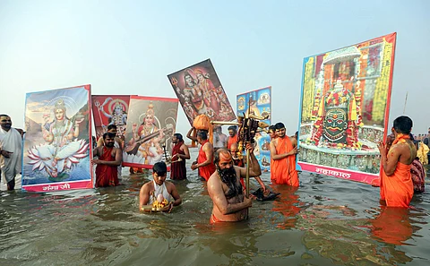 Sadhus offer prayers after taking a holy dip at Sangam confluence of River Ganga Yamuna and Saraswati on 'Mauni Amavasya' during the ongoing annual 'Magh Mela' festival in Prayagraj. (Photo | PTI)