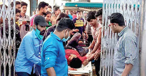 A man injured in clashes during the fourth phase of Bengal elections in Cooch Behar is brought to a hospital on Saturday. (Photo | PTI)