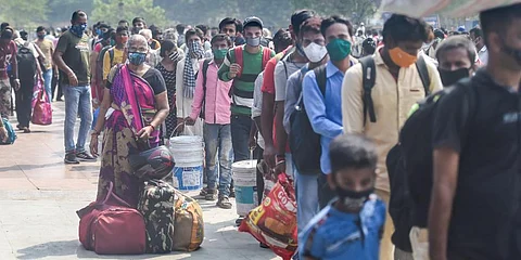 Passengers gather at the Lokmanya Tilak Terminus to board outstation trains, amid the ongoing spike in COVID-19 cases. (Photo | PTI)