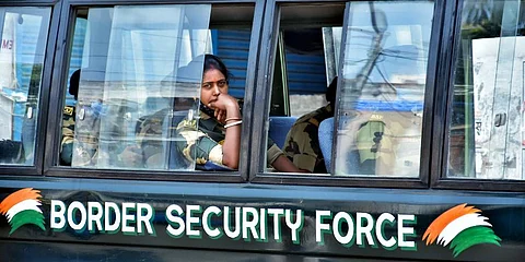 A woman personnel looks while sitting inside a BSF vehicle deployed at a polling booth during the 7th phases of the West Bengal assembly election. (Photo | ANI)