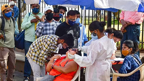 A medic conducts COVID-19 testing of a tourist at Gateway of India as others wait for their turn. Image used for representational purposes only.