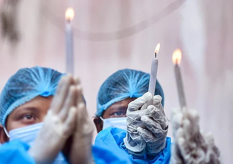 Nurses of a Covid hospital offer prayer to mark International Nurses Day, which commemorates the birthday of Florence Nightingale, in Kolkata. (Photo | PTI)