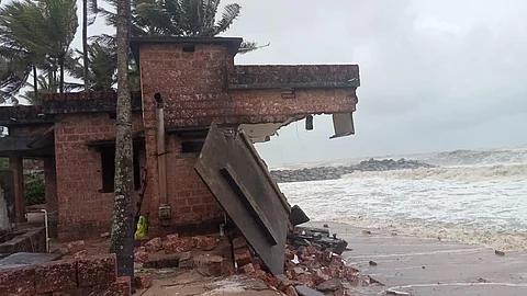 Advancing waves bring down two houses on Moosodi beach in Mangalpady. Coastal erosion may claim seven more houses if the cyclone does not abate, say residents. (Photo | Special arrangement)