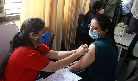 A health worker administers COVID-19 vaccine dose to a student at a vaccination centre organised for the students travelling abroad for higher studies, in New Delhi.