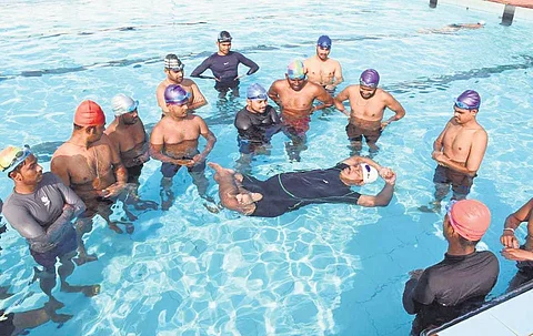 Ashok Baral demonstrating aqua yoga in a swimming pool | Express