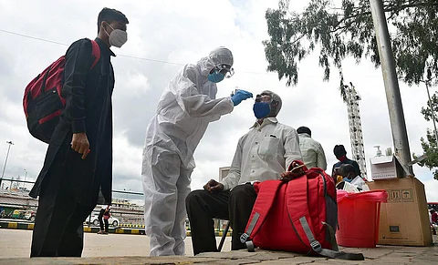 A health worker collects swab samples of a passenger. Image used for representational purposes only.