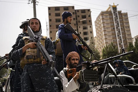 Taliban fighters escort women march in support of the Taliban government outside Kabul University, Afghanistan, on Saturday, Sept. 11, 2021. (Photo | AP)
